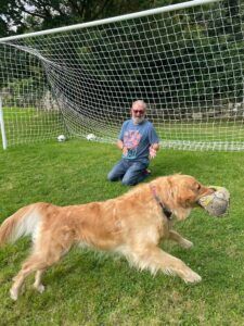 Discount code for Trusted House Sitters to save 25% — Pet sitter and golden retriever dog playing football
